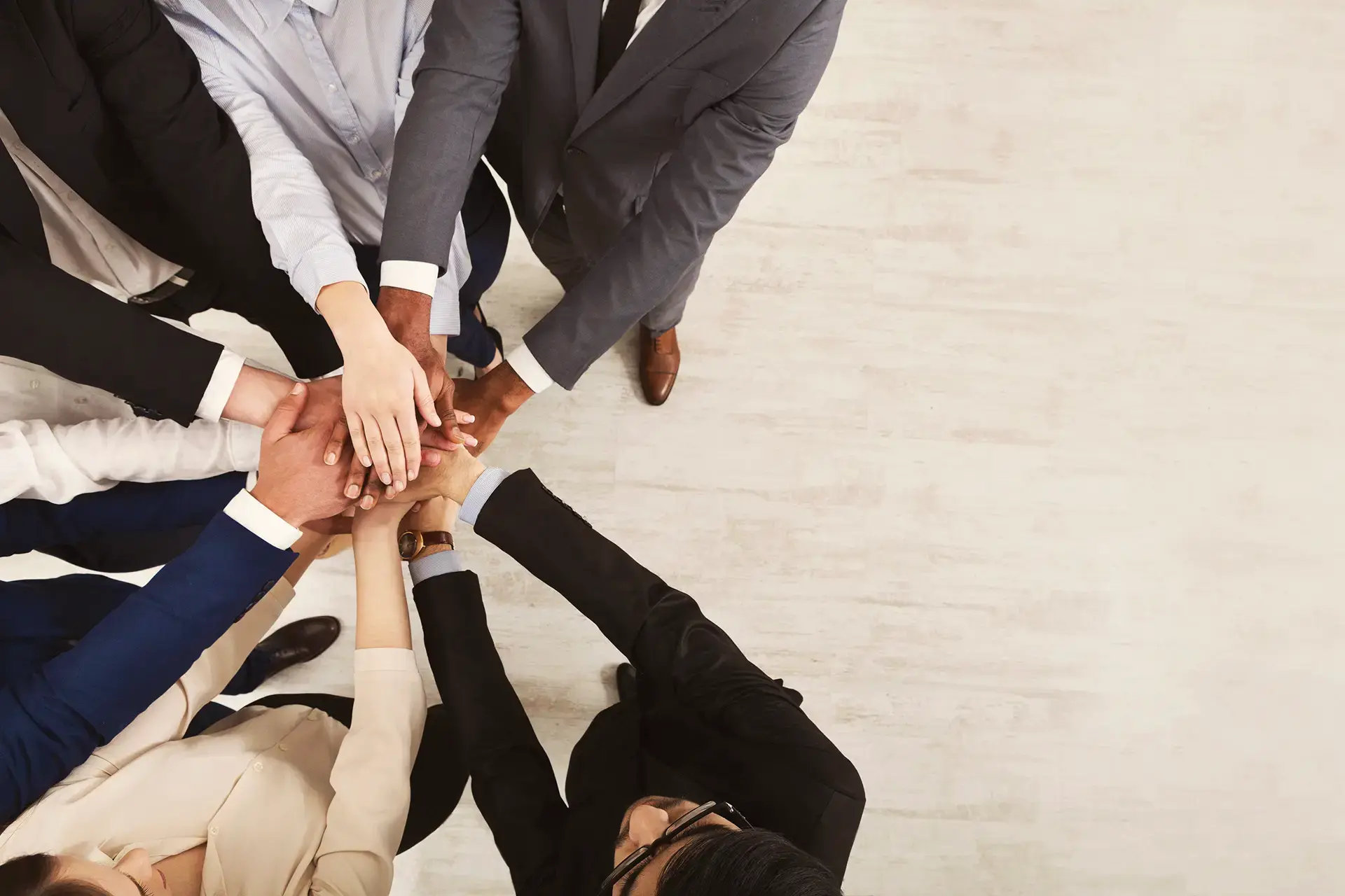 Entdecke unsere Partner - Foto mehrere Leute in Businesskleidung legen ihre Hände zusammen